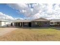 Ranch-style home with dark gray exterior and carport at 2047 W Maryland Ave, Phoenix, AZ 85015