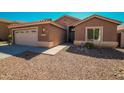 One-story home with a tan exterior and gravel landscaping at 7469 W Monona Dr, Glendale, AZ 85308