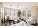 Light-filled living room with hardwood floors, a cozy seating area, and large windows at 19777 N 76Th St # 2233, Scottsdale, AZ 85255