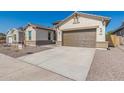 New construction home exterior with two-car garage at 21048 E Arroyo Verde Dr, Queen Creek, AZ 85142
