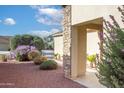 Side yard view of house with landscaping and walkway at 12956 W El Sueno Ct, Sun City West, AZ 85375