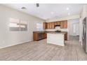 Spacious kitchen with an island, stainless steel appliances, and wood cabinets at 10722 W Jefferson St, Avondale, AZ 85323