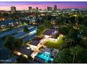 Stunning aerial view of a home with a pool and city skyline at 341 E Monte Vista Rd, Phoenix, AZ 85004