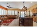 Open kitchen with island, copper pot rack, and leather seating at 4333 S Pony Rider Trl, Gold Canyon, AZ 85118
