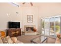 Bright living room boasts a fireplace and sliding glass doors to patio at 25515 N Forest Rd # 30, Rio Verde, AZ 85263