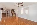 Spacious living room with wood-look tile and staircase at 18337 W Stinson Dr, Surprise, AZ 85374