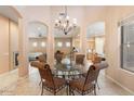 Formal dining room featuring a glass-top table and chandelier at 7473 E Soaring Eagle Way, Scottsdale, AZ 85266