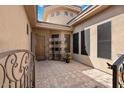 Private courtyard entry with tile flooring and wrought iron gate at 7473 E Soaring Eagle Way, Scottsdale, AZ 85266