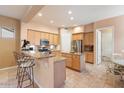 Spacious kitchen with light wood cabinets and granite countertops at 7473 E Soaring Eagle Way, Scottsdale, AZ 85266