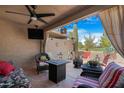 Relaxing patio with fire pit and wicker furniture at 10224 E Michigan Ave, Sun Lakes, AZ 85248