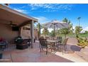 Covered patio with seating area, umbrella, and golf course view at 10224 E Michigan Ave, Sun Lakes, AZ 85248