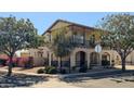 Two-story house with Spanish-style architecture, balcony, and landscaped yard at 15409 W Corrine Dr, Surprise, AZ 85379