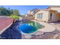 Inviting kidney-shaped pool with flagstone decking at 15409 W Corrine Dr, Surprise, AZ 85379