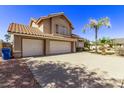 Three-car garage and driveway of a two-story house at 2726 N Ricardo --, Mesa, AZ 85215