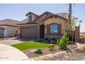 New construction home with stone accents and a two-car garage at 22427 E Oriole Way, Queen Creek, AZ 85142
