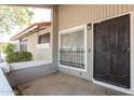 Exterior view of a condo with a cactus-design door at 4820 N 89Th Ave # 100, Phoenix, AZ 85037