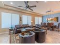 Open living room with ample natural light and a ceiling fan at 16917 W Sheridan St, Goodyear, AZ 85395