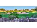 View of a green golf course from behind a fence at 22455 N 55Th St, Phoenix, AZ 85054