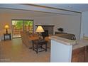 Living room with tiled floors, fireplace and patio access at 7435 E Sundance Trl # 403, Carefree, AZ 85377