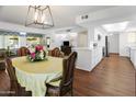 Dining room with a table, chairs, and open kitchen view at 9701 W Oak Ridge Dr, Sun City, AZ 85351