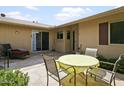 Stone patio with table and chairs, adjacent to home at 9701 W Oak Ridge Dr, Sun City, AZ 85351