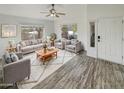 Bright living room featuring wood-look floors and comfy seating at 563 S 230Th Ave, Buckeye, AZ 85326