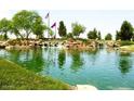Serene community lake with walking paths and mountain views at 20620 N Confetti Ct, Maricopa, AZ 85138