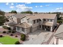 Two-story house with a three-car garage and landscaped yard at 1392 E Baker Dr, San Tan Valley, AZ 85140