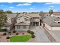 Aerial view of a two-story house with a landscaped yard and driveway, offering a comprehensive view at 1392 E Baker Dr, San Tan Valley, AZ 85140