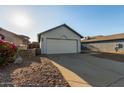 House exterior with white garage door and landscaping at 7394 N 67Th Dr, Glendale, AZ 85303