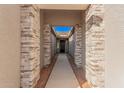 Covered entryway with stone pillars and a walkway at 16970 W Baker St, Surprise, AZ 85387