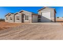 Newly built home with gray exterior, stone accents, and attached garage at 16970 W Baker St, Surprise, AZ 85387