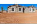 Newly constructed home with gray exterior and stone accents at 16970 W Baker St, Surprise, AZ 85387