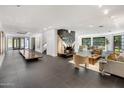 Open living room with a stunning marble fireplace and dark tile floors at 6644 E Exeter Blvd, Scottsdale, AZ 85251