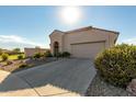 Tan house with arched entryway and two-car garage at 19104 N Smith Dr, Maricopa, AZ 85139
