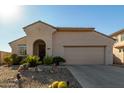 Tan house with arched entryway and two-car garage at 19104 N Smith Dr, Maricopa, AZ 85139