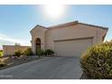 Tan house with arched entryway and two-car garage at 19104 N Smith Dr, Maricopa, AZ 85139