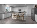 Modern kitchen with white cabinets, granite countertops, and an island at 3721 S 83Rd Dr, Tolleson, AZ 85353