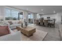 Spacious living room with light flooring and access to kitchen and dining area at 3721 S 83Rd Dr, Tolleson, AZ 85353