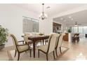 Open concept dining room with adjacent kitchen and breakfast bar at 13618 W Shifting Sands Dr, Peoria, AZ 85383