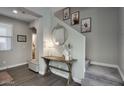 Bright entryway with console table, mirror, and staircase at 14231 W Bronco Trl, Surprise, AZ 85387