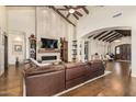 Living room with a large stone fireplace and hardwood floors at 5039 S 158Th St, Gilbert, AZ 85298