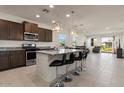 Modern kitchen with an island and stainless steel appliances at 42165 W Sunflower Rd, Maricopa, AZ 85138