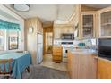 Galley kitchen with wood cabinets and appliances at 7750 E Broadway Rd # 277, Mesa, AZ 85208