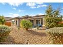 Landscaped backyard with a covered patio and gravel at 26803 W Firehawk Dr, Buckeye, AZ 85396