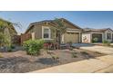 Modern house with a two-car garage and desert landscaping at 3103 E Hayfield Way, San Tan Valley, AZ 85140