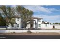 Two-story house with landscaping and a white exterior at 2060 E Quartz St, Mesa, AZ 85213