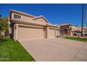 Three-car garage and a two-story house at 192 W Los Arboles Dr, Tempe, AZ 85284