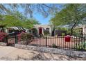 House with red door and a well-maintained yard, black metal fence at 2322 N 8Th St, Phoenix, AZ 85006