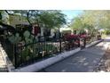 Charming house with lush landscaping, cacti, and a black metal fence at 2322 N 8Th St, Phoenix, AZ 85006